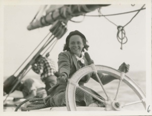 Image of Jean Edwards at wheel on Board the Thebaud